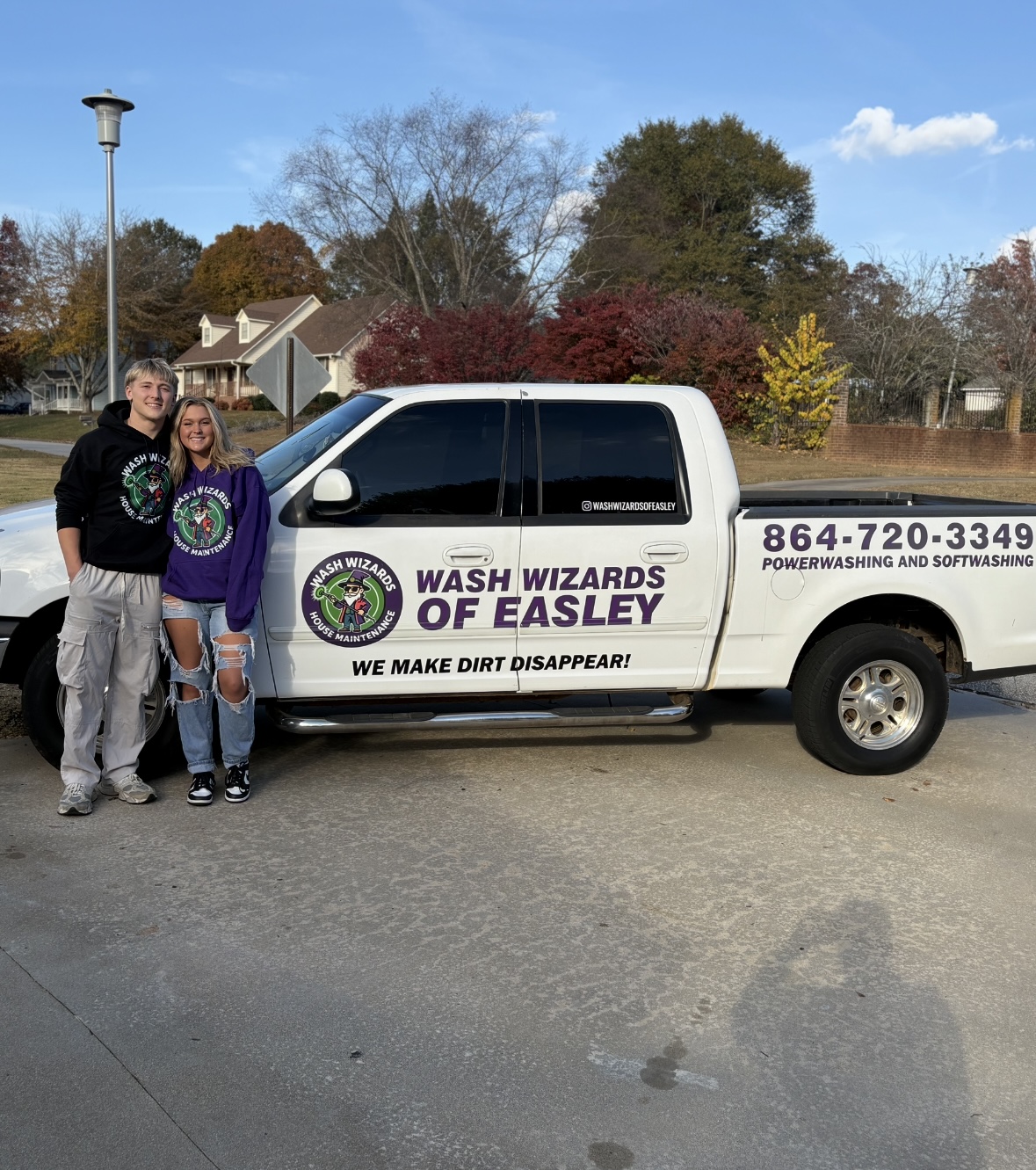 Owners of Wash Wizards of Easley standing beside their branded work truck